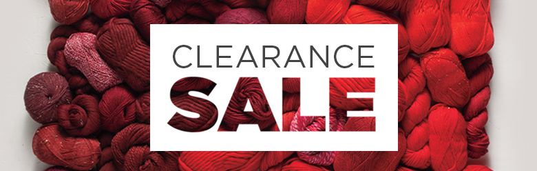 a large selection of red yarn with the words clearance sale written across it.
