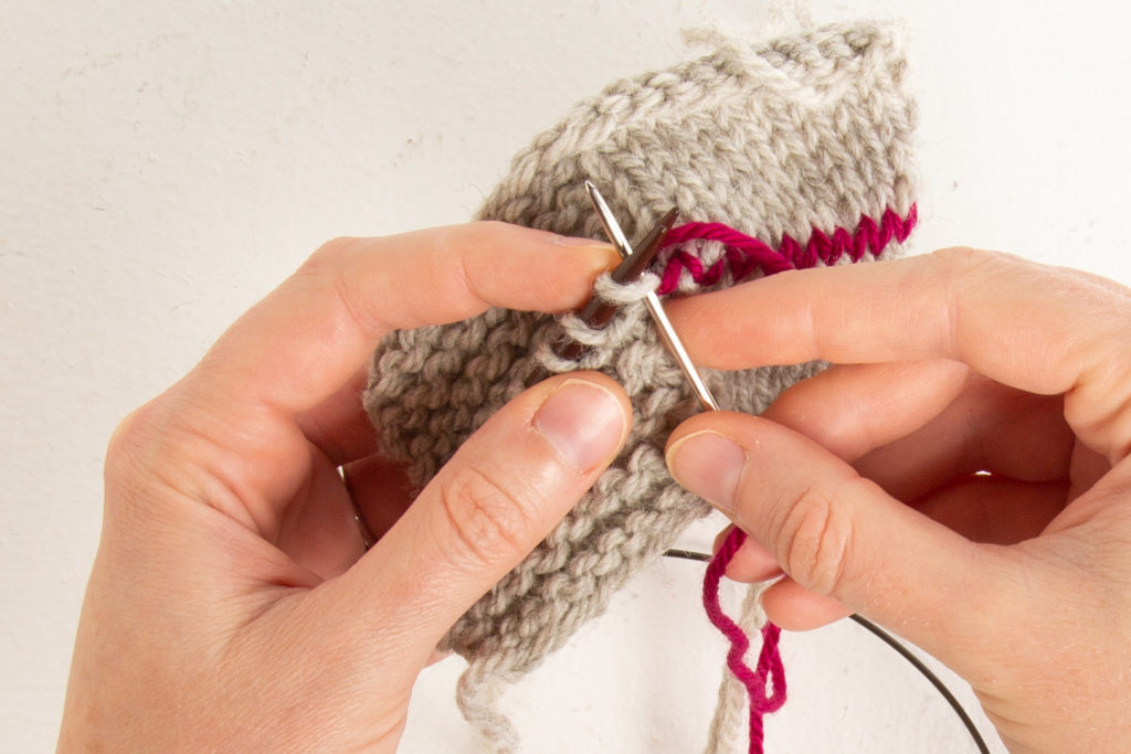 garter step 1: through front first stitch knit-wise