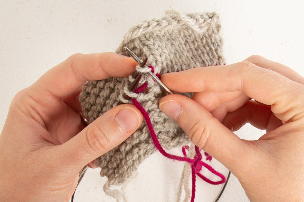 garter step 3: through back first stitch knit-wise