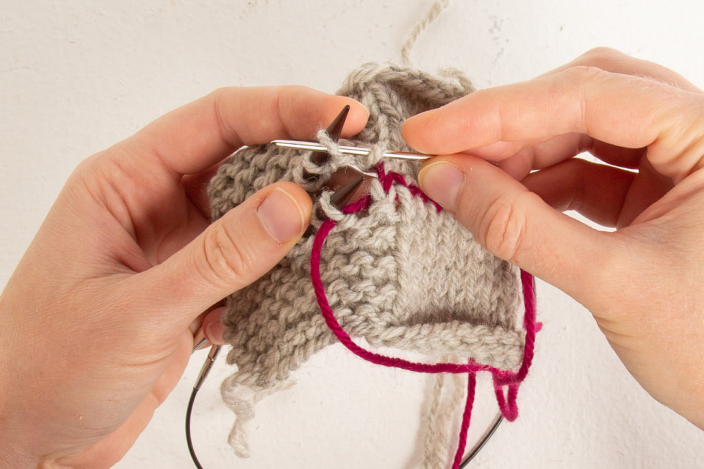 garter step 4: after dropping first stitch off needle, through next back stitch purl-wise