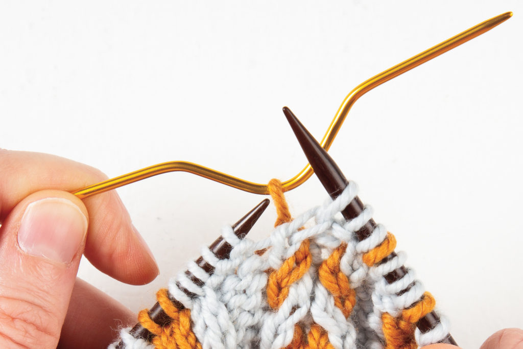 1-over-1 cable Right: first stitch knit, with cable needle in back