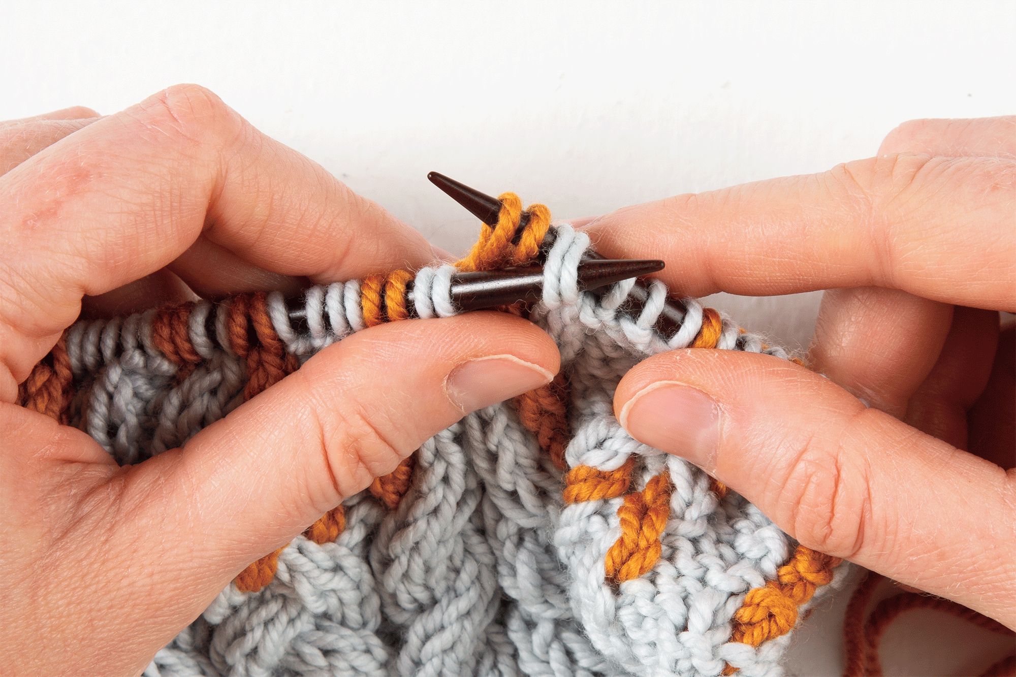 animation: 2-over-2 cable Left, without a cable needle: slip the other 2 stitches off of then back onto the right-hand needle, behind the front 2 stitches
