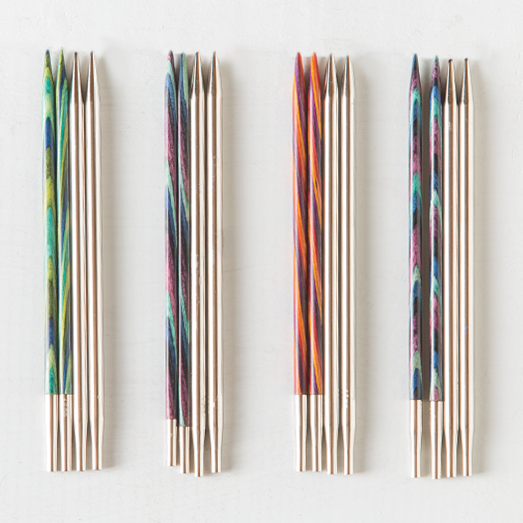 On a white background, four groups of interchangeable knitting needles in various styles.