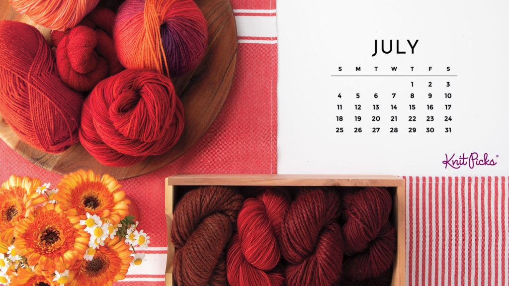 A July 2021 calendar with an image of a pile of red yarn, a box of red yarn, and some yellow flowers